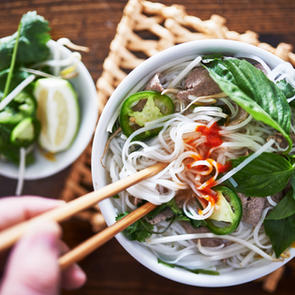 A bowl of pho topped with jalapeño